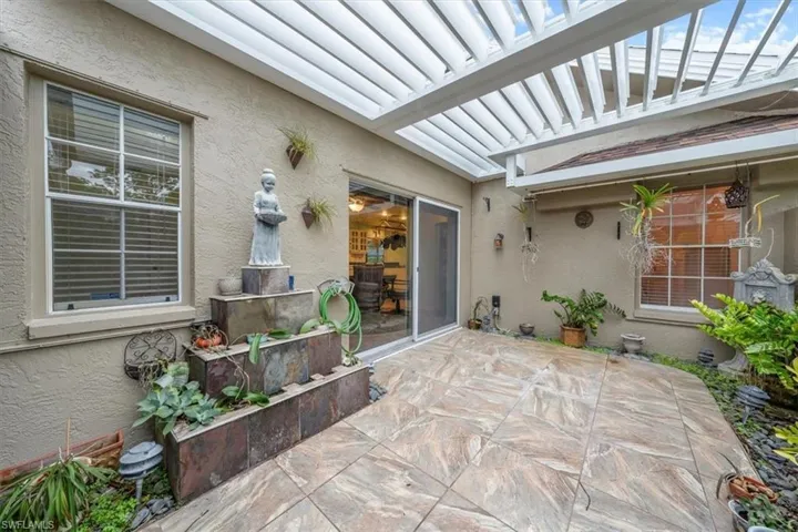 Pergola with motorized louvered roof
