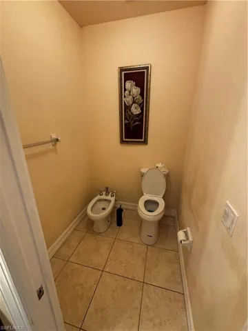 Bathroom featuring light tile patterned floors and a bidet