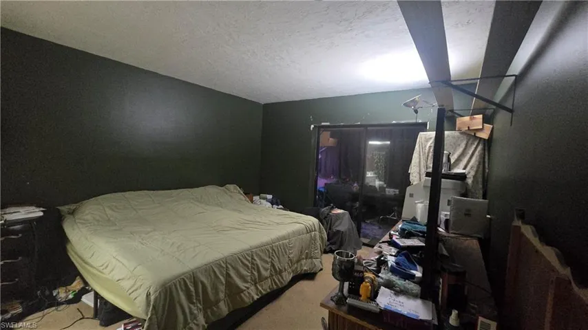 Carpeted bedroom with a textured ceiling
