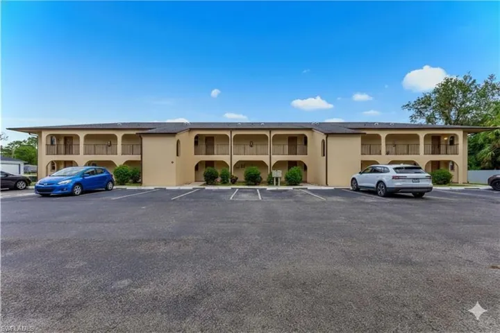 View of property with uncovered parking