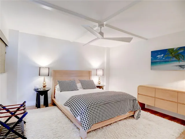 Bedroom with ceiling fan and hardwood / wood-style floors