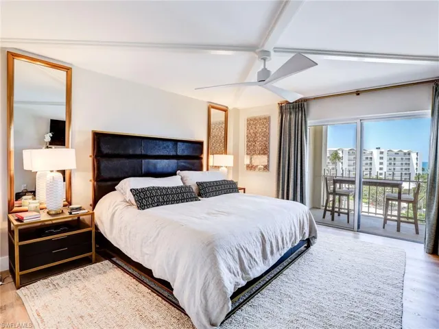 Bedroom with access to outside, ceiling fan, light hardwood / wood-style floors, and beam ceiling