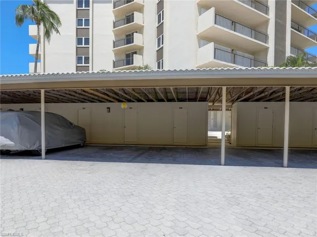 View of parking / parking lot with a carport