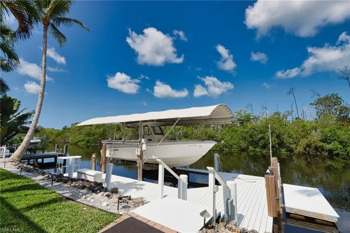 Dock with boat lift and a water view