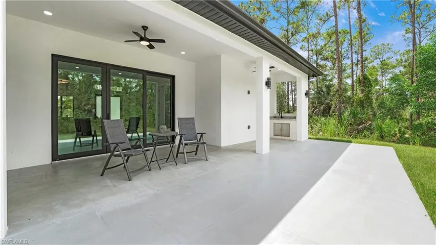 View of patio featuring ceiling fan, area for grilling, and outdoor dining space