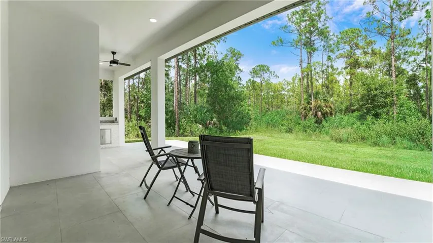 View of patio with ceiling fan and outdoor dining space