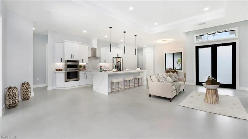 Living room featuring recessed lighting, french doors, and ornamental molding