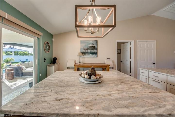 View from the kitchen island looking towards the master bedroom and outdoors to the pool area!