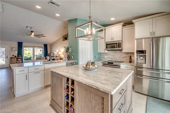 Beautiful full height backsplash, staggered custom cabinets and upgraded stainless steel appliances!