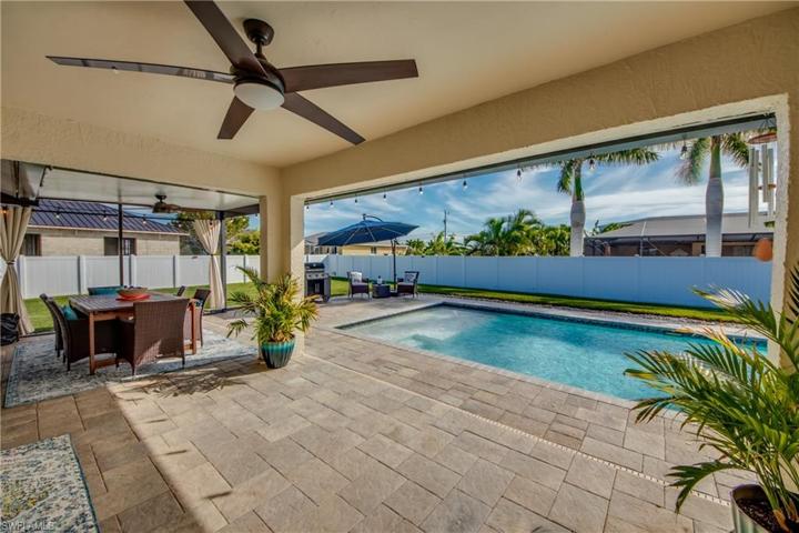 STUNNING!  The whole back yard is like your own private resort!  Extensive patio, pavers green green grass and tons of room on both sides of the home!
