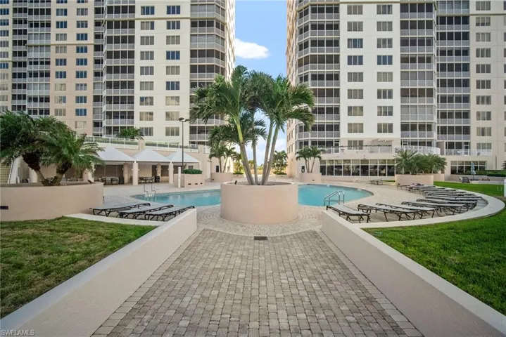 Community pool with a lawn and a patio