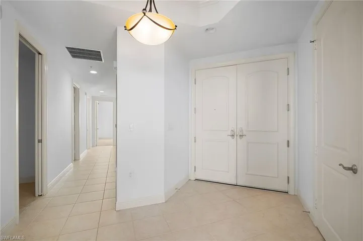 Hall featuring recessed lighting and light tile patterned floors