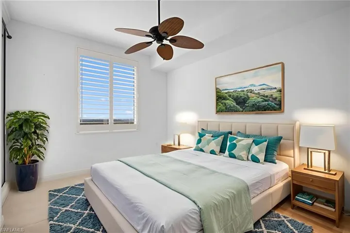 Carpeted bedroom with baseboards and a ceiling fan