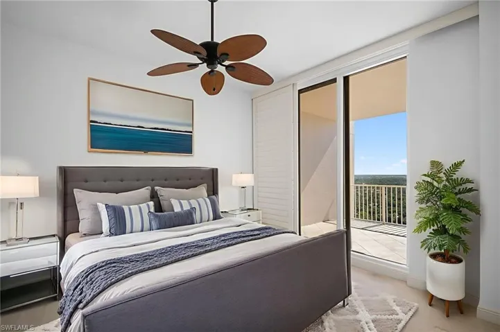 Carpeted bedroom with access to exterior and ceiling fan