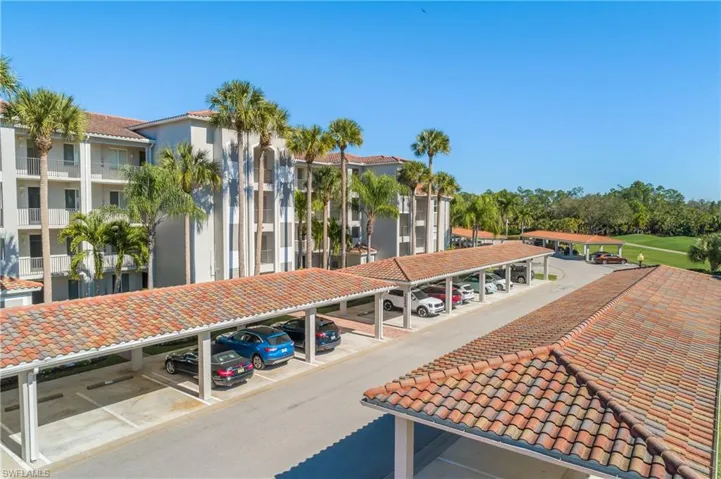 View of community featuring covered parking