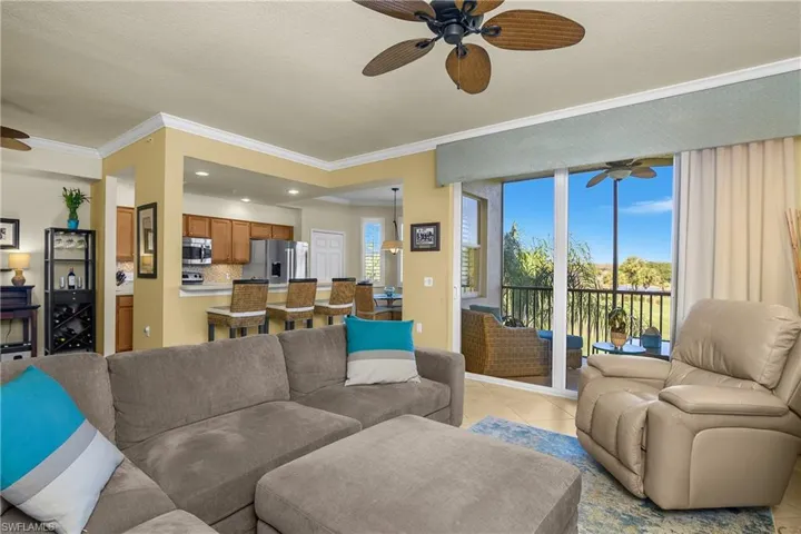 Living area featuring a ceiling fan, light tile patterned flooring, crown molding, recessed lighting,