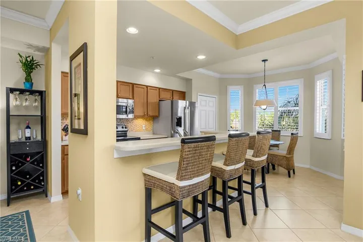 Kitchen with a breakfast bar, light countertops, tasteful backsplash, and stainless steel appliances