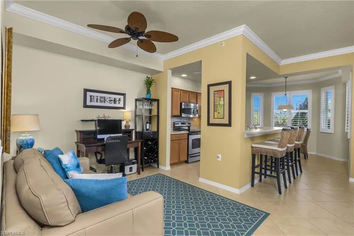 Flex room dining/den area featuring a ceiling fan, light tile patterned floors, crown molding, and recessed lighting