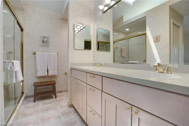 upstairs primary bath with dual sinks and shower.