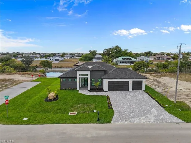 View of front facade with a residential view, a shingled roof, a front lawn, and decorative driveway