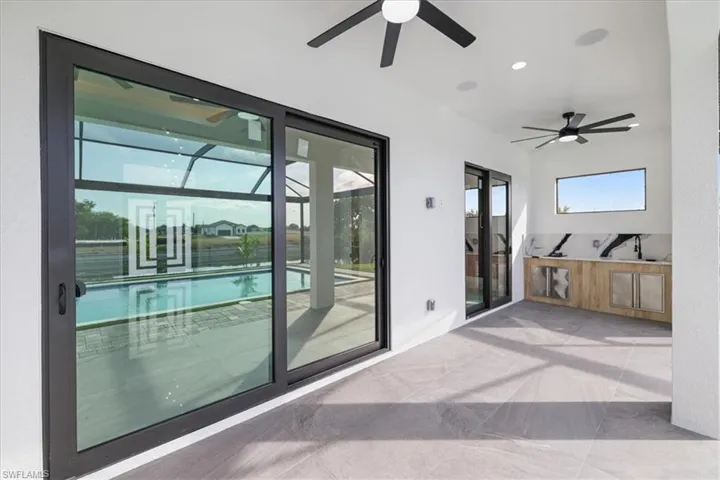 Doorway featuring a sunroom and recessed lighting