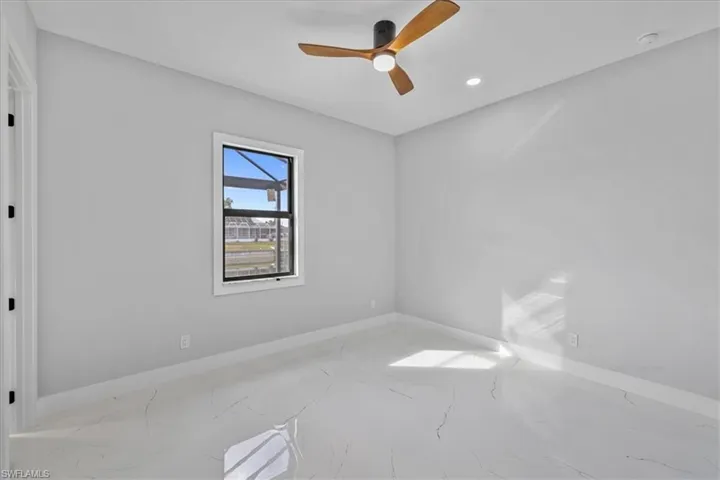 Spare room featuring ceiling fan, marble finish flooring, and recessed lighting