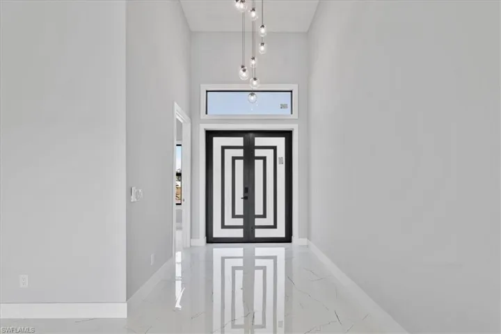 Entryway featuring light marble finish floors