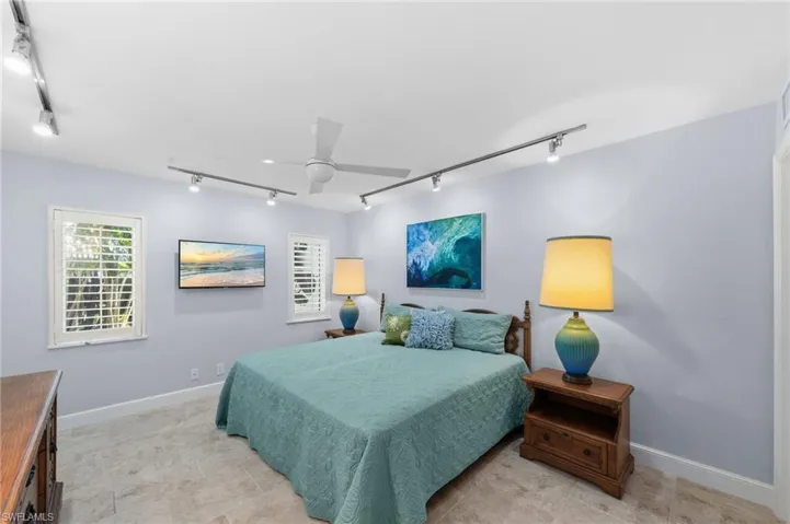 Bedroom featuring track lighting and a ceiling fan