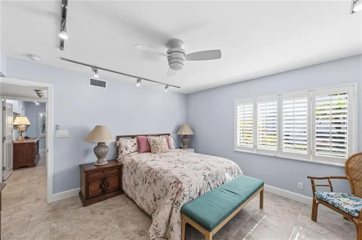 Bedroom featuring rail lighting and ceiling fan