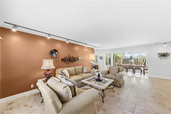 Living area with track lighting and baseboards