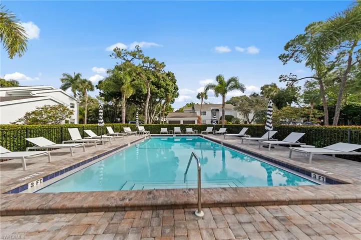 Community pool with a patio