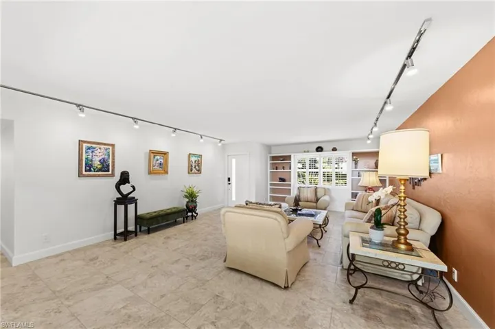 Living room with rail lighting and baseboards