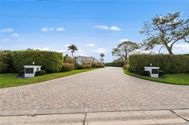 View of home's community with decorative driveway