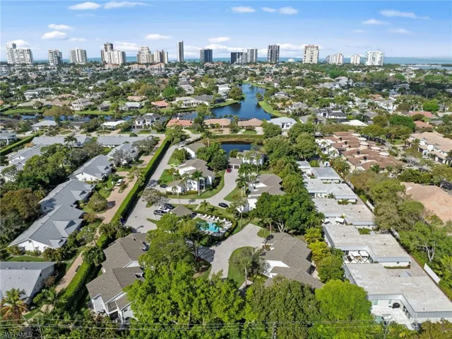 Aerial view of residential area featuring skyline and a large body of water