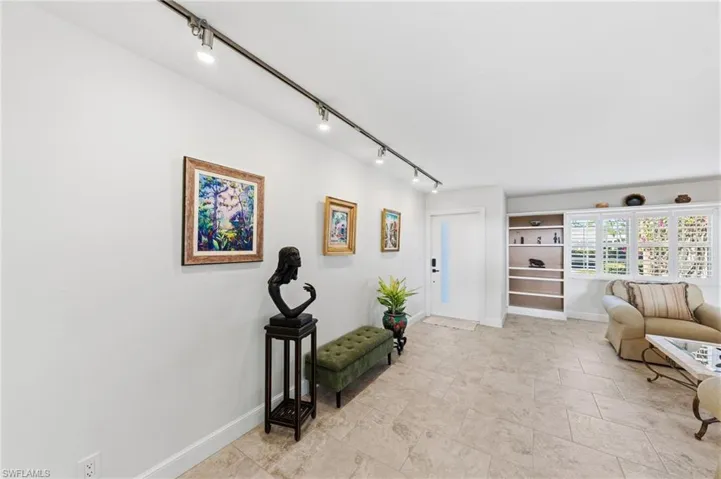 Living area featuring track lighting and baseboards