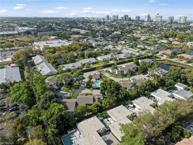 Aerial view of residential area with city skyline and a nearby body of water