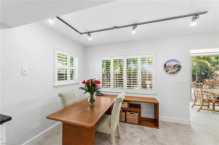 Dining room featuring rail lighting and baseboards