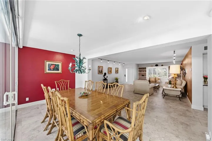 Dining space featuring rail lighting and baseboards