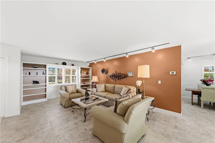 Living area with track lighting and plenty of natural light