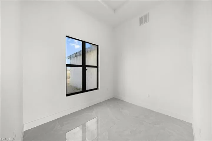 Spare room featuring baseboards