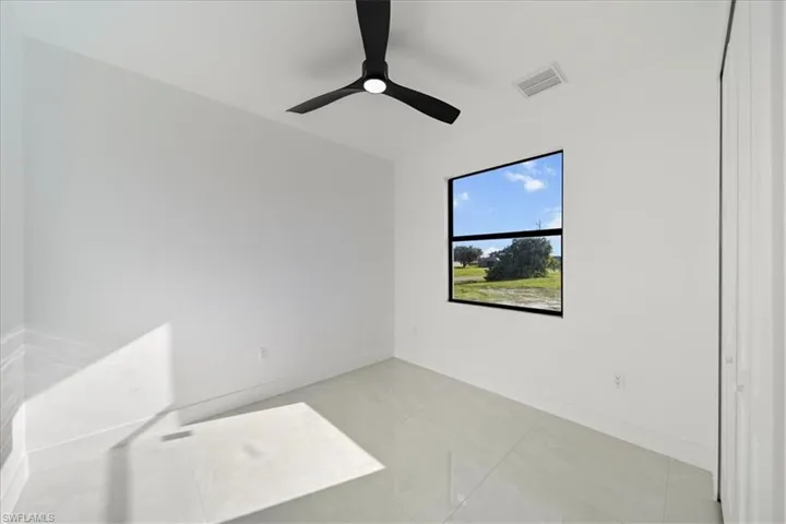 Unfurnished room featuring baseboards and ceiling fan