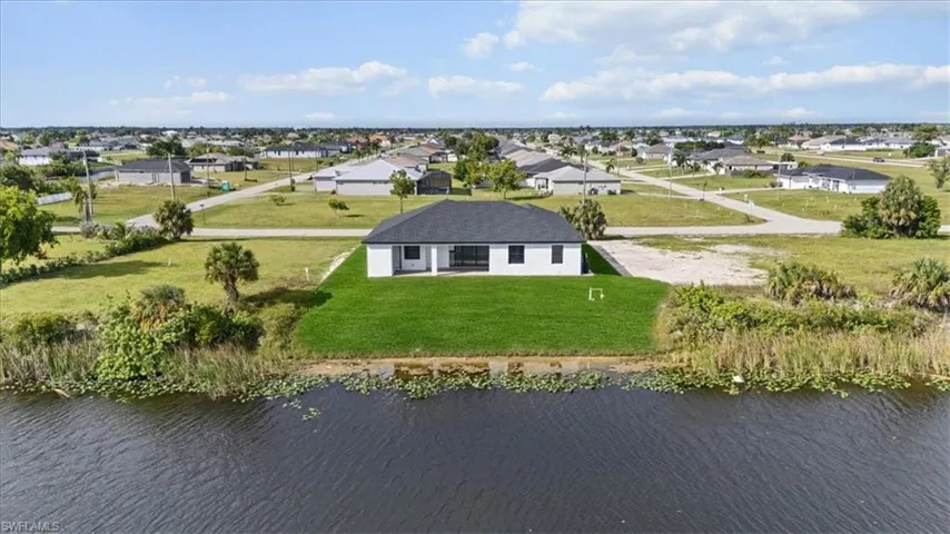 Aerial perspective of suburban area with a large body of water