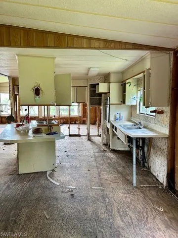 Kitchen featuring a sink and light countertops