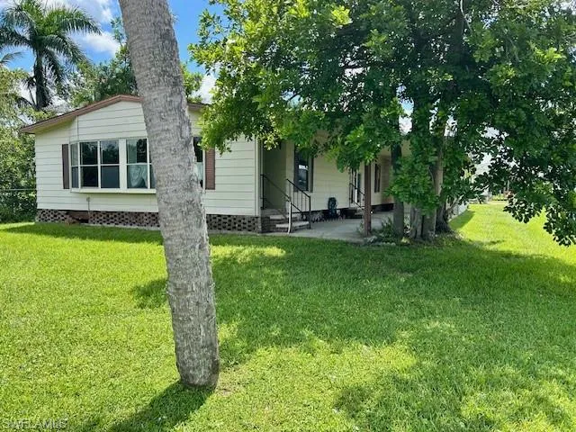 Back of property with a patio and a yard