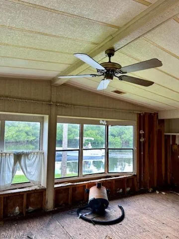 Sunroom featuring vaulted ceiling