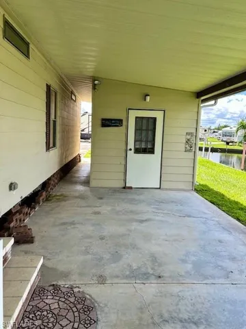 Property entrance featuring a patio area and a water view