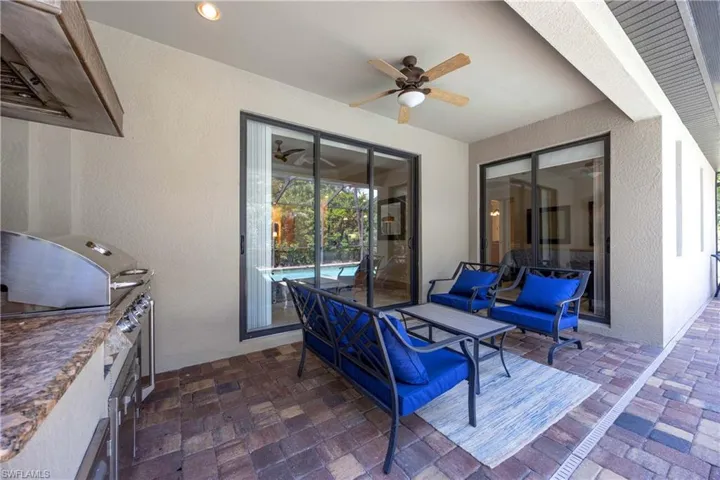 View of patio featuring grilling area, exterior kitchen, and ceiling fan