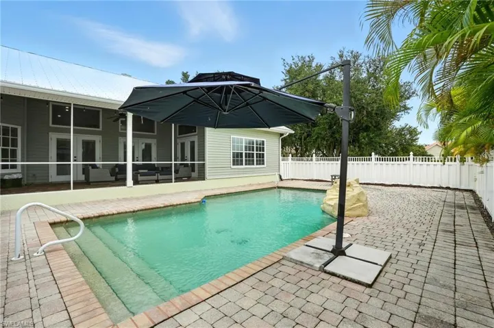 View of pool featuring a patio area and a fenced backyard