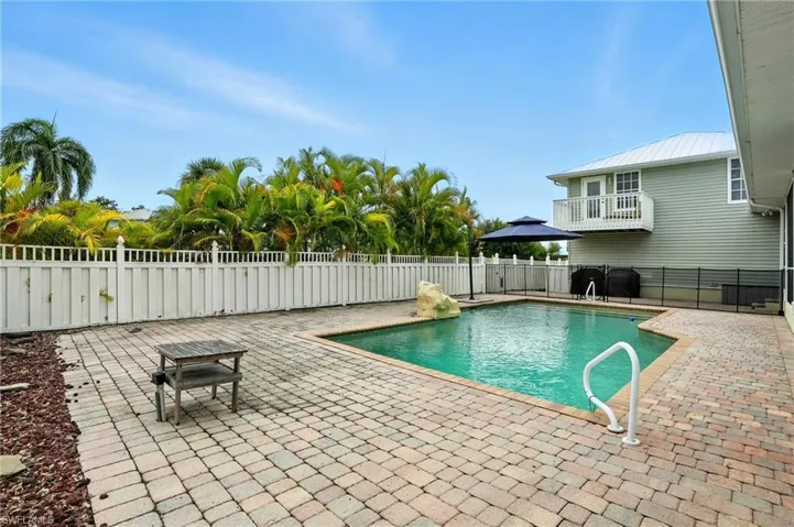 View of pool with a patio area and a balcony