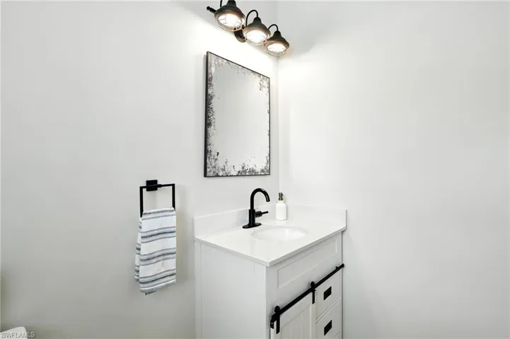 Half bathroom featuring vanity